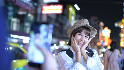 Travel concept. Young female tourists taking pictures and playing in the city. 4k Resolution.