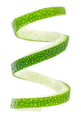 Peel of fresh lime over white background, closeup.