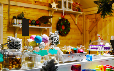 Handmade Soap Souvenirs at stalls during Christmas market in Vilnius, Lithuania. Wooden balls in jar as decoration in home. Street Xmas holiday fair. Advent and Stalls with Crafts Items on Bazaar