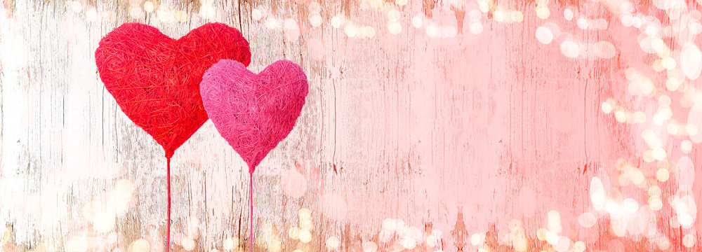 Valentines day background panorama banner long -  two red hearts balloons and bokeh lights on rustic bright wooden texture