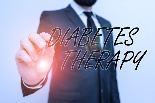 Writing note showing Diabetes Therapy. Business concept for aim to achieve lower average blood glucose results Male human with beard wear formal working suit clothes hand