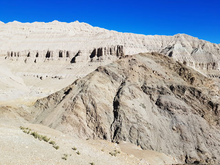 Ancient Tholing Monastery, Tibet. Ruins of ancient capital of Guge kingdom. Cave town inside a pyramid-shaped rock and a royal palace on the top.