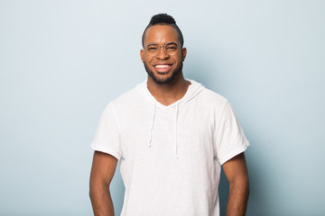 Smiling happy African American man in glasses looking at camera