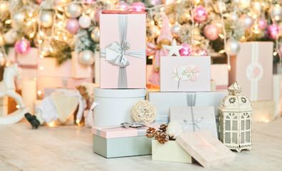 Christmas gift boxes on a background of a Christmas tree