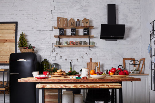 Christmas kitchen interior. Christmas decor and tree in the room. Christmas interior in the loft style. Christmas at home.