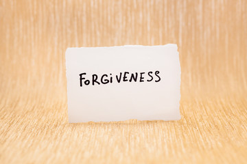 Forgiveness - card with lettering on glitter gold background, christian concept