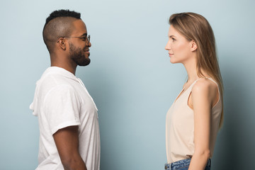African American man and Caucasian woman looking at each other