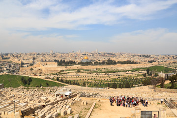 Fototapeta na wymiar Mount of Olives Jewish Cemetery and Jerusalem Old city cityscape panorama with Dome of the Rock with gold leaf and Al-Aqsa Mosque on Temple Mount and Rotunda of Church of the Holy Sepulchre, Israel