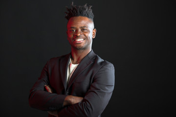 Fototapeta premium handsome african man in suit on black background