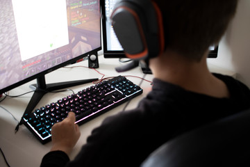 boy playing computer games at home