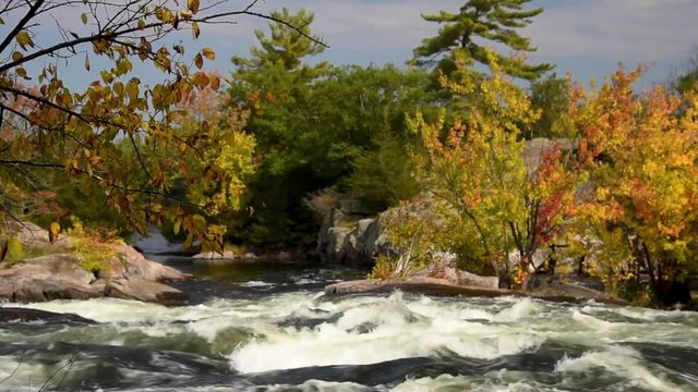 fast moving water in river cascade in autumn