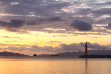 Fototapeta premium Seascape at sunset. Lighthouse on the coast. Seaside town of Turgutreis and spectacular sunsets