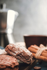 Homemade bakery, chocolate cookies, cinnamon sticks close-up view, with copy space