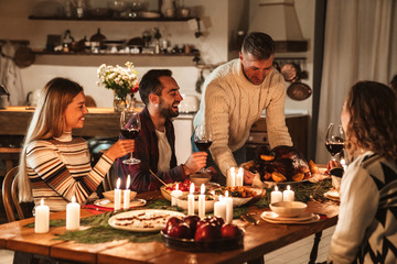Photo of caucasian excited people having Christmas dinner with turkey