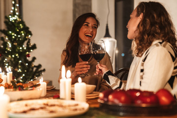 Photo of excited caucasian women having Christmas dinner