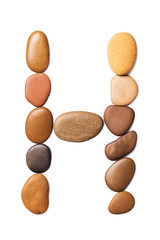 Letter H made of marine small pebbles, top view. Alphabet made of stones Isolated on a white background