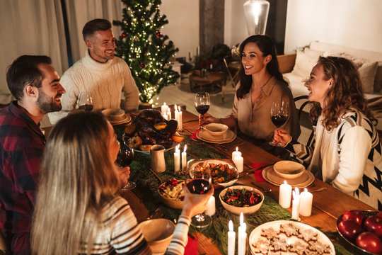 Photo of caucasian excited people having Christmas dinner with turkey