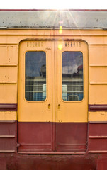 Fototapeta na wymiar metal doors on the train, orange train doors