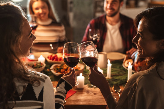 Photo of nice joyful people drinking wine and having Christmas dinner