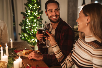 Photo of beautiful cheerful people having Christmas dinner