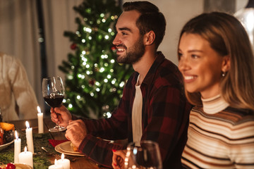 Photo of beautiful cheerful people having Christmas dinner