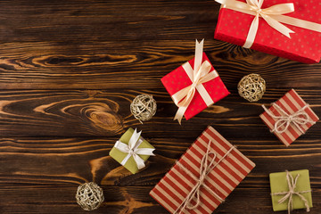 Gifts on wooden background, top view