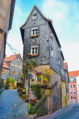 Furth, Germany, 21 November 2019: street name Pfarrgasse. Narrow alley with tall artistically...