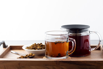 Natural, organic Chaga mushroom and chaga mushroom tea served on a wooden tray.