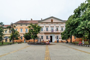 Fototapeta na wymiar Kikinda, Serbia - July 26, 2019: National Museum building and beautiful fountain with sculpture 