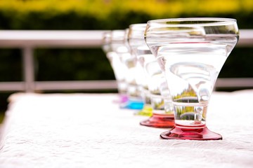 Colorful drinking glasses on white background