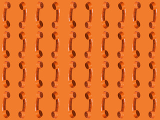 Seamless pattern of an orange retro style telephone