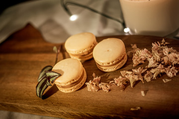 Tasty sweet macaroon cookies on wooden display