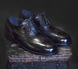 Obraz na płótnie Canvas top view of black leather shoes on white