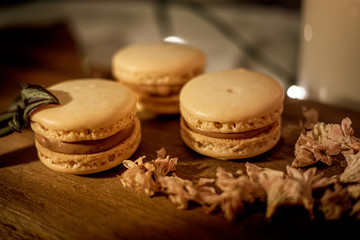Tasty sweet macaroon cookies on wooden display