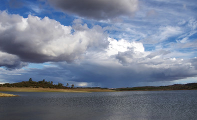 Obraz premium cloudy sky and alqueva lake near Amieira village, Portugal