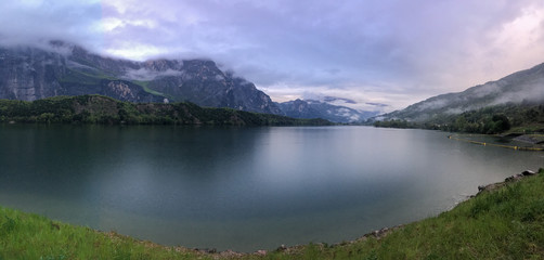 Naklejka na ściany i meble Lago Cavedine, Cavedine, Trentino, Italy. Lake with reflection, mountains and rocks.