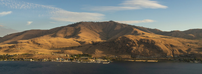 Panoramic View of Lake Chelan lake and nearby hills nearing sunset