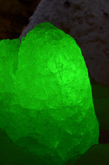 Translucent ice aggregate shine by vibrant green, illuminated from behind. A false-crystal of water...