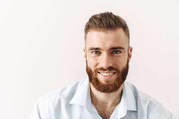Businessman isolated posing over white wall background.