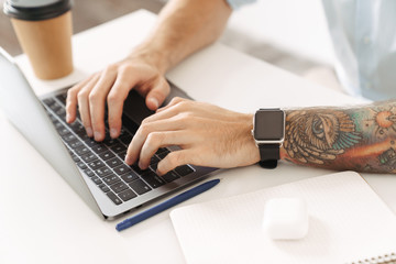Businessman isolated using laptop computer sit at the table.