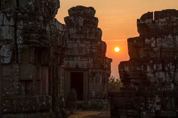Romantic silhouette of love couple on the Pre Rup temple in Angkor during sunset.