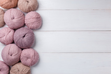 Woolen skeins of thread on white boards. ball of thread from Italian Angora. A knitting project is...