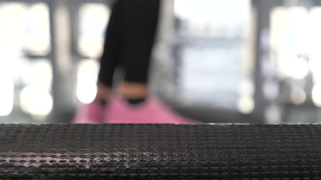 treadmill movement, man training. close-up. legs of girl in sneakers go along treadmill. Strengthening muscles of the legs when walking. cardio load. Sport lifestyle concept. weight loss in gym.