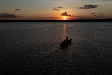 Silhouette of boat on the river at sunset