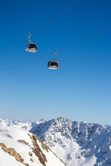 Fototapeta na wymiar Two Gondola cable car cabins in Alps in Solden, Tirol, Austria