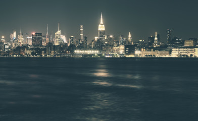 New York City panorama at night, color toning applied, USA.