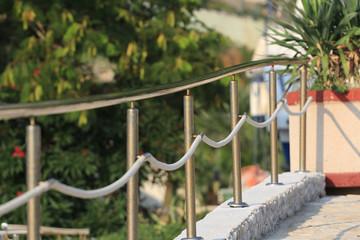Metal railing with white ropes