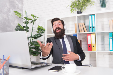 Naklejka premium Cant resist music. Businessman enjoy music in office. Bearded man listen to music and sing along to song. Insurance agent wear headphones playing music. Modern life. New technology