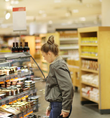 Woman choosing a dairy products at supermarket	