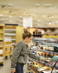 Woman choosing a dairy products at supermarket	